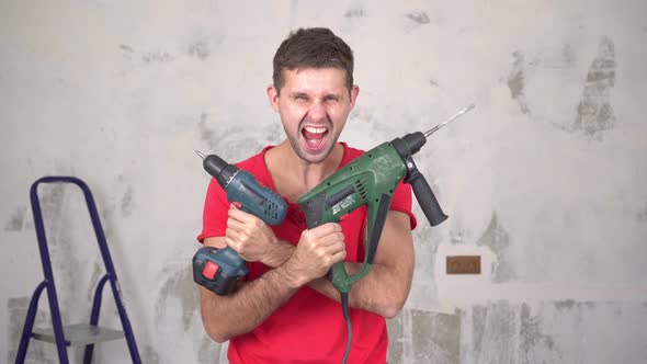 A Portrait of a Brutal, Cheerful, Crazy Man with Electric Tools While Renovating an Apartment