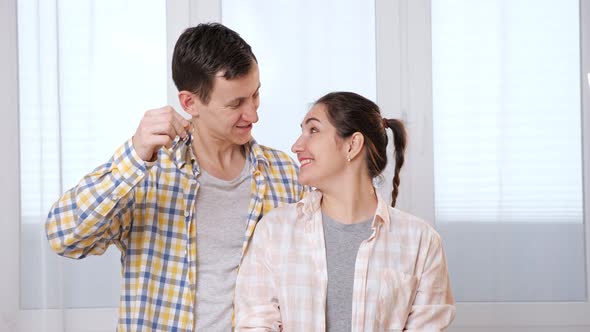 Husband Shows Keys To Hew House To Surprised Wife in Room