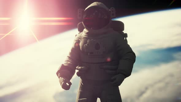 Astronaut in Outer Space Over the Planet Earth