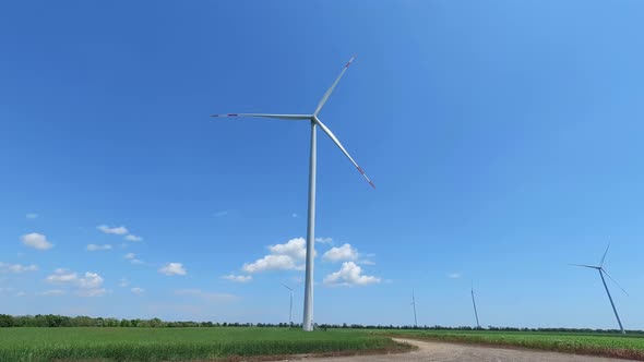 Electric windmill with long blades close-up. Wind turbine for the production of electricity.