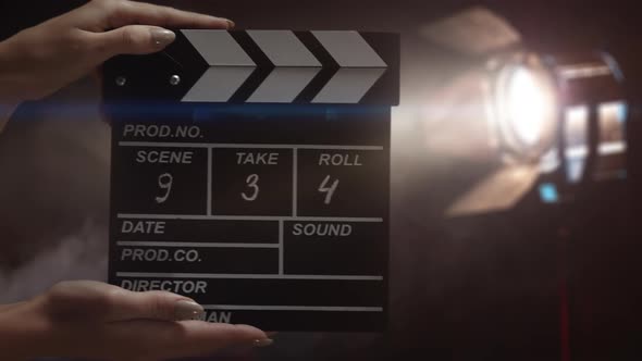 Human Hands are Using a Clapperboard on Set