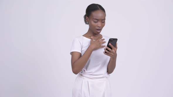 Young Stressed African Woman Using Phone and Getting Bad News