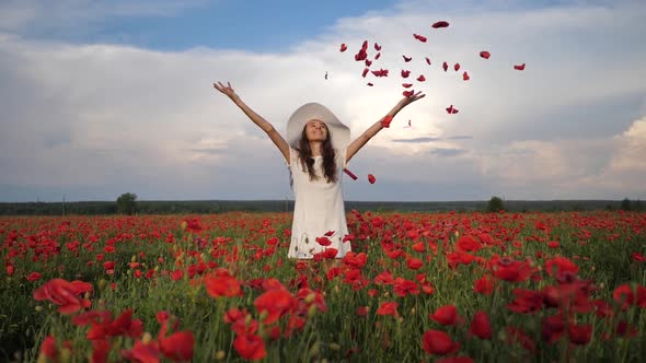 Happy Woman in White Dress and Hat on Poppy Flowers Field at Summer Blue Deep Sky and Clouds