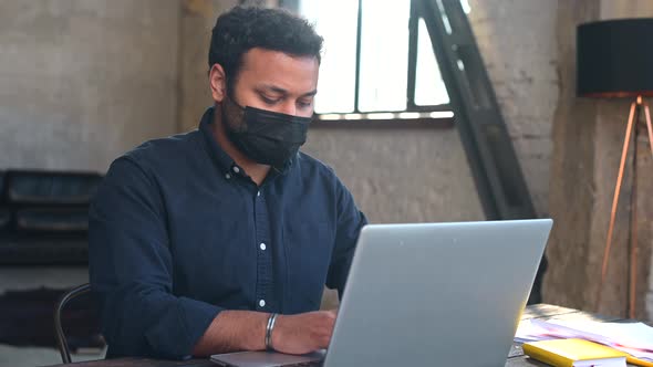 Hindu Mixedrace Male Employee Wearing Protective Face Mask Working in the Office