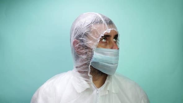 Man in Protective Suit Medical Mask and Gloves Looking in Camera