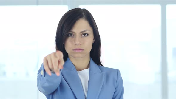 Young Businesswoman Pointing Toward Camera