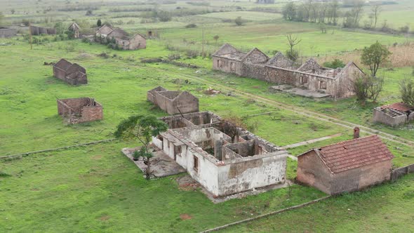 Roofless derelict buildings in an abandoned farm deserted due to rural flight - migration to cities