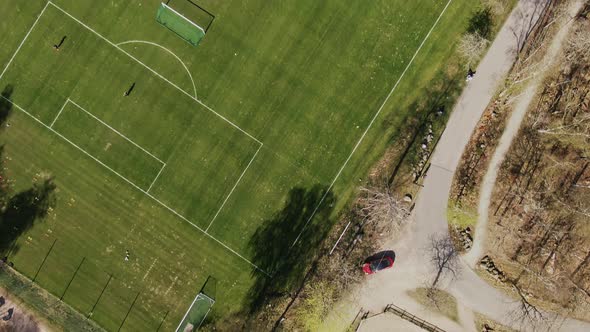 Drone shot facing down on soccer training grounds on sunny spring day