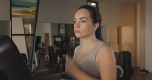 Young Indian Woman Working Out on a Treadmill in a Fitness Room