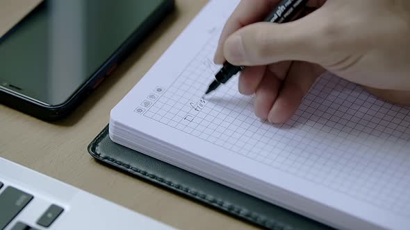 Caucasian Male Hand Writing a Plan in a Dairy