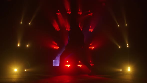 Silhouette of a Talented Young Hip Hop Dancer. Hip Hop Street Dance on a Stage in Dark Studio with