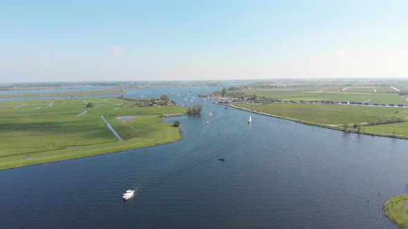 Motorboats and sailboats on inland waterways, 4K aerial view on summer day