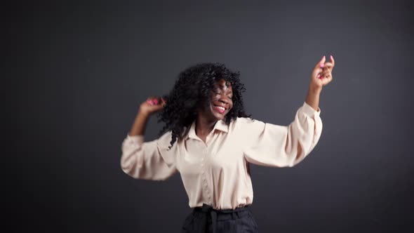 Afroamerican Lady with Curly Hair Dances at Show Tryout