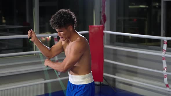 Training in Sport Club Young African Man is Skipping Rope in Gym