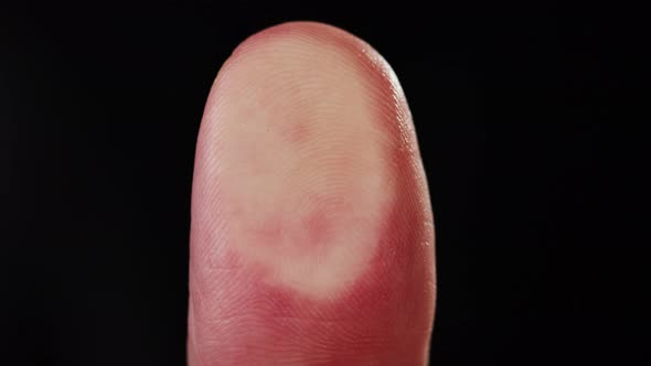 Human Hand Making Fingerprint on Black Background