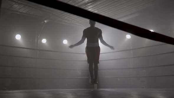 Boxer jumping rope in boxing ring