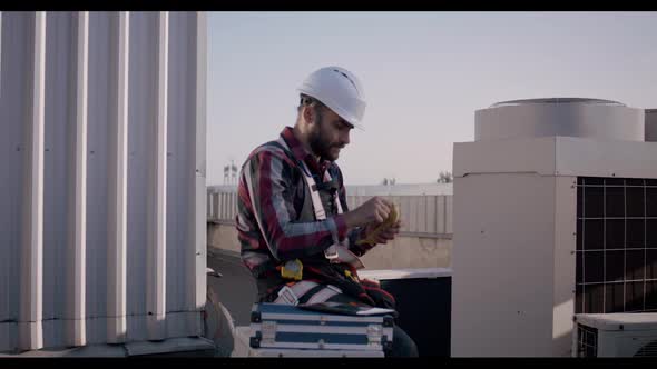 Engineer Eating a Banana During His Break