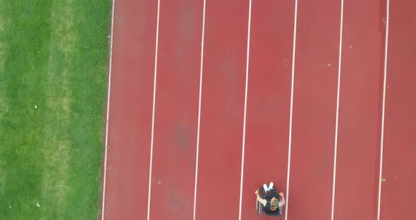 A Female Person with Disabilities Has a Workout Exercise in a Wheelchair on Training at the