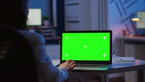 Woman Looking at Laptop with Green Mockup During Night Time