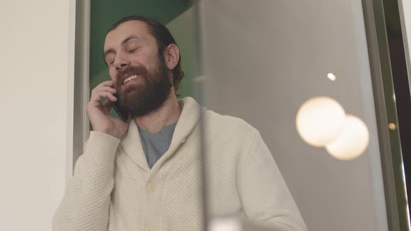 Bearded Man Finishing Phone Conversation