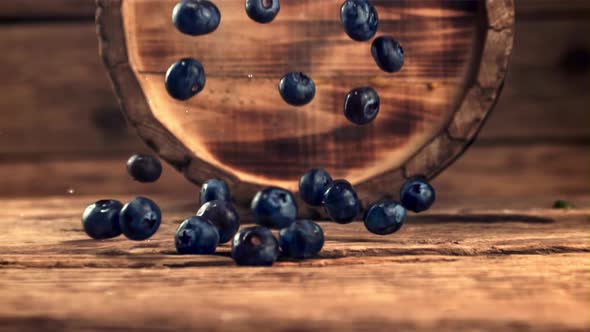 Super Slow Motion Fresh Blueberries Fall on the Table