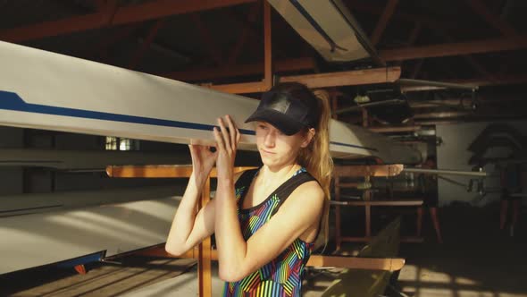 Female rower carrying a scull