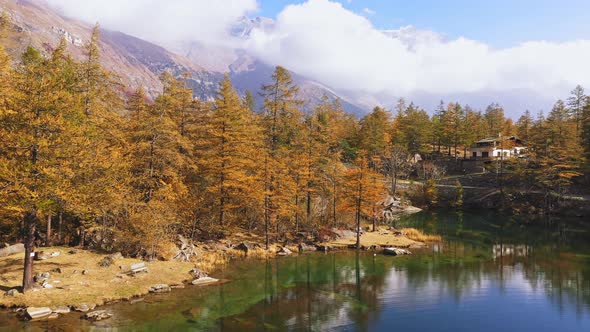 Aerial View Flying Over Mountain Lake in Autumn Color Foliage