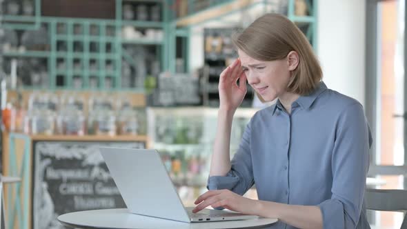 Young Woman with Headache Working on Laptop