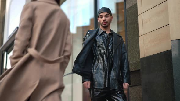 Selfish Young Gay Man Looking with Mocking Facial Expression at Woman Passing in City Center