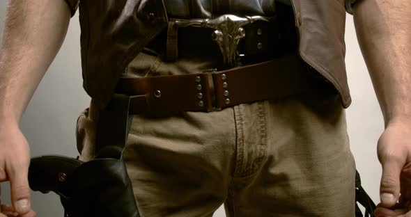 Close up of a cowboy with a gun, holding onto his belt with a bull on it, 4k