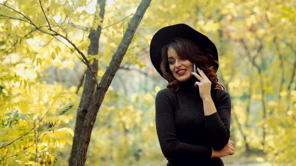 Woman posing in park. Happy young woman posing in autumn park