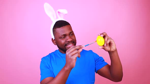 Happy Young Brazil Man with Bunny Ears in Studio Pink Wall Background