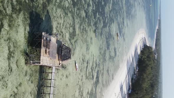 Vertical Video House on Stilts in the Ocean on the Coast of Zanzibar Tanzania Aerial View