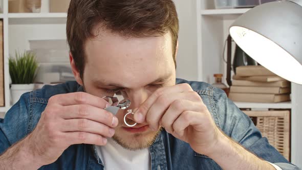 Jewelry Expert Checking Diamond Ring