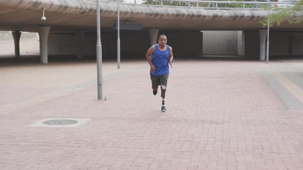 Front view man with prosthetic leg running