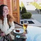 Girl Sit in a Cafe on the Street Talking on the Phone - VideoHive Item for Sale