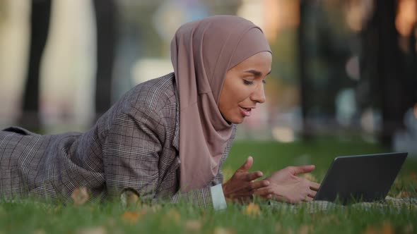 Friendly Islamic Business Woman Muslim Girl in Hijab Lying Grass Lawn in Park Outdoors Female