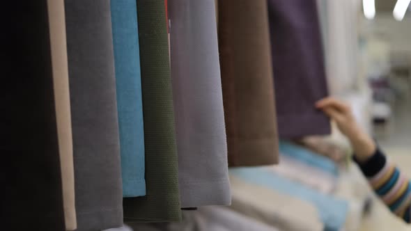 Customer Choosing Fabric for Curtains in a Store