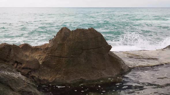 Waves crashing over Oahu's volcanic rocks.