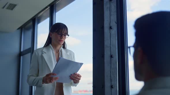 Focused Businesswoman Checking Documents in Office