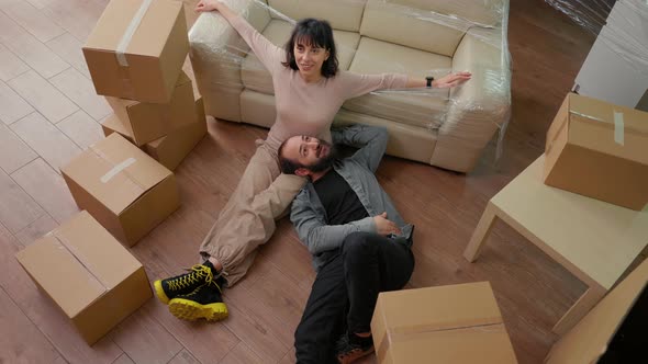 Life Partners Sitting on Apartment Floor After Moving in Together