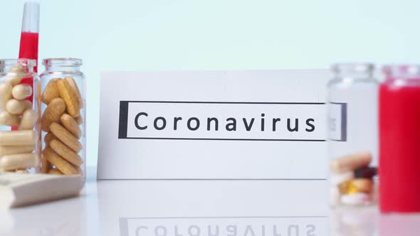 CORONAVIRUS Inscription Plate on the Background Are Pills a White Background. Novel Coronavirus