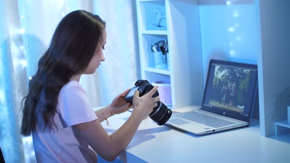 Woman Looking Through Photos From Camera in Front of Laptop