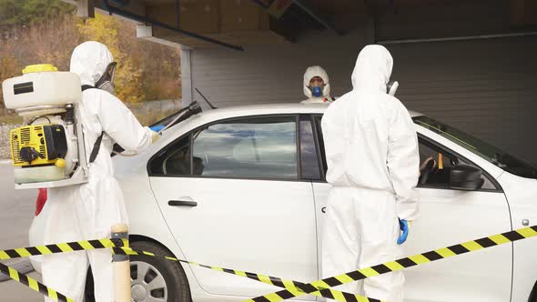 Cleaners Disinfecting the Automobile After Being in Coronavirus Quarantine Zone Covid19