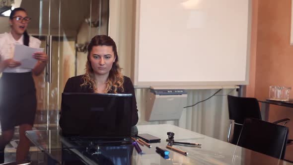 Two Business Women in Business Clothes in the Office Experience a Sense of Joy and Delight After One