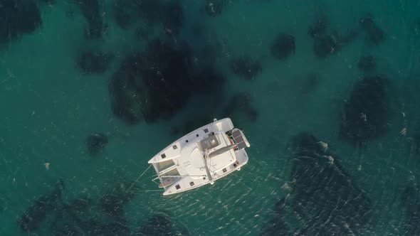 Aerial view of a catamaran anchored in Aegean sea, Greece.