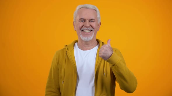 Happy Grandfather Showing Thumbs-Up and Smiling on Camera, Like, Recommendation