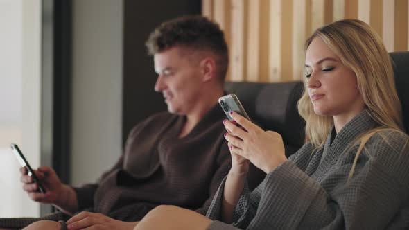 Blonde Woman and Her Husband are Resting Together in Spa Salon Relaxing After Treatments in Loungers