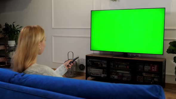 Woman Looking at Green Screen TV Chroma Key Mock Up Display Change Channels