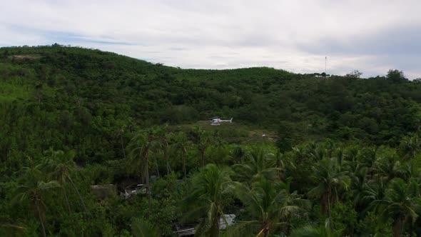Helicopter On The Vast Greenery In Fiji On A Cloudy Day - aerial